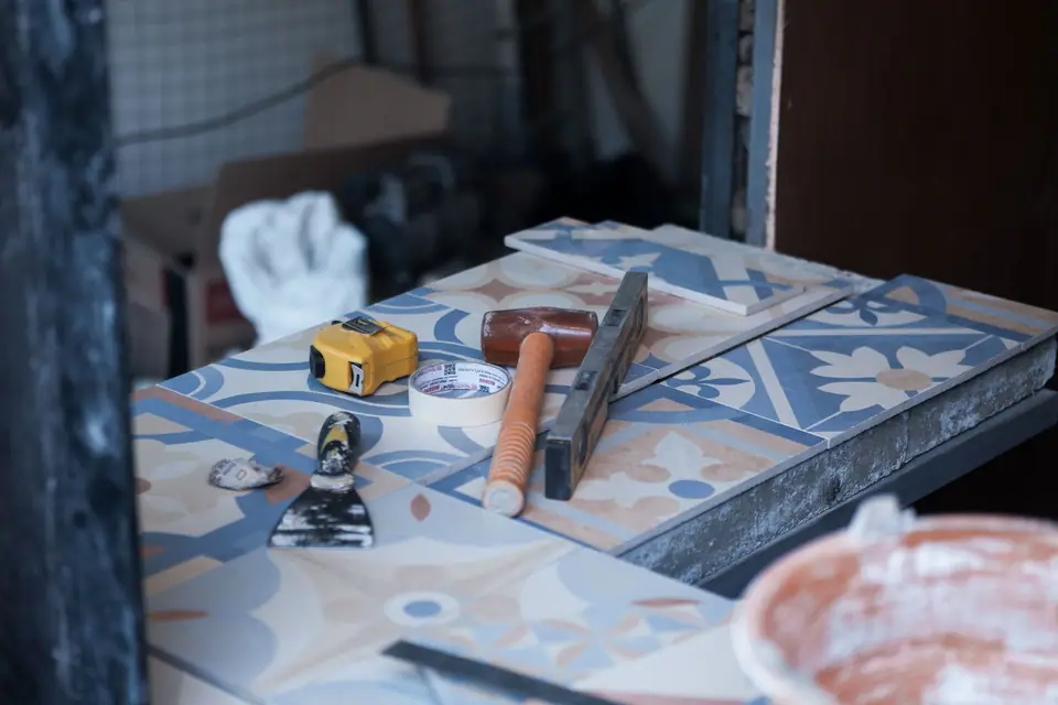 Ferramentas de assentamento, trena e ladrilhos decorados em uma obra